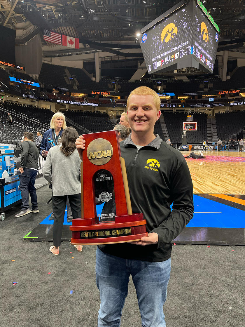 University of Iowa grad Carter Shockey holding a trophy at a basketball tournament