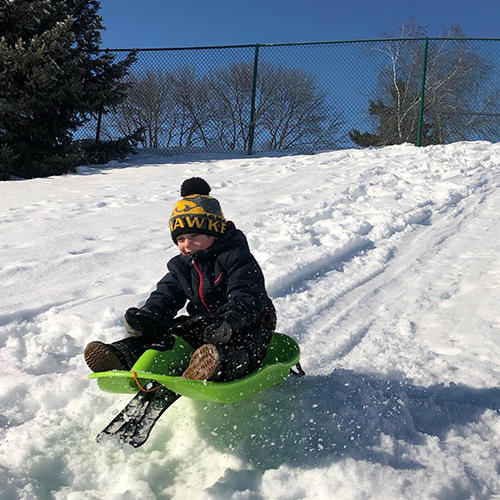 Tate Manahl rides a sled