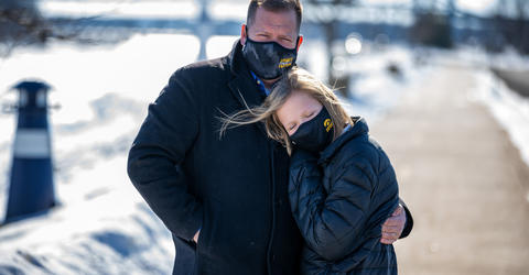 Daniel Ivory and his daughter Lydia wearing face masks with Tiger hawk logos, standing outdoors on a sunny winter day