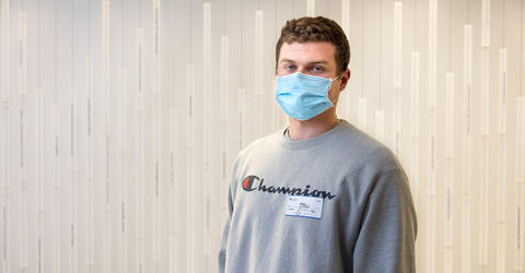 a man stands in the corridor of a health care facility