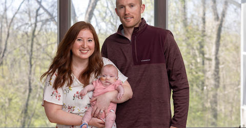 Emily and Ted Eilers hold their daughter Evelyn at their home