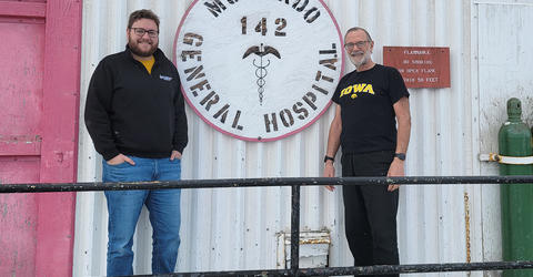 two university of Iowa medicine alums stand at a research station in antarctica