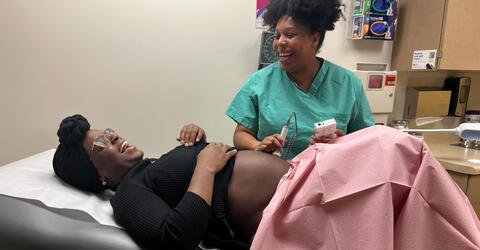 an obgyn shares a laugh with a patient during a medical visit