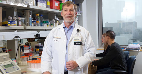 University of Iowa cancer researcher George Weiner standing in his lab