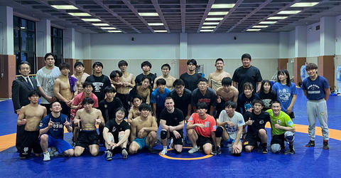 University of Iowa alumnus and wrestling icon Spencer Lee poses for a photo with wrestlers from Yamanashi Gakuin University in Kofu, Japan