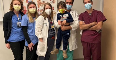 a young boy with health care professionals at the university of iowa