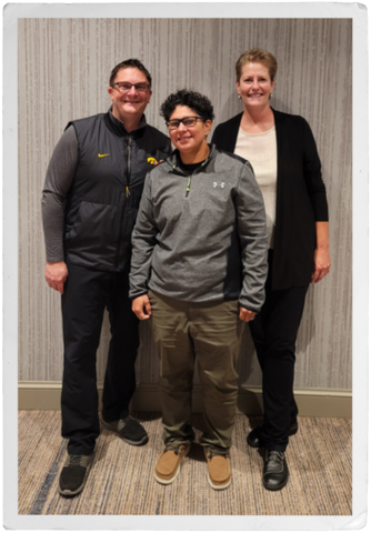 a man and two women who work in law enforcement pose together in a hallway
