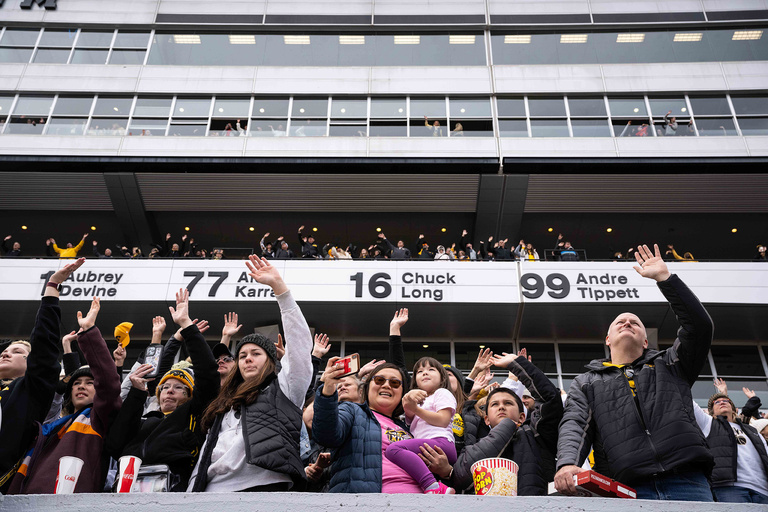 fans at Kinnick Stadium waving to the children's hospital at the end of the first quarter of the Crossover at Kinnick basketball game