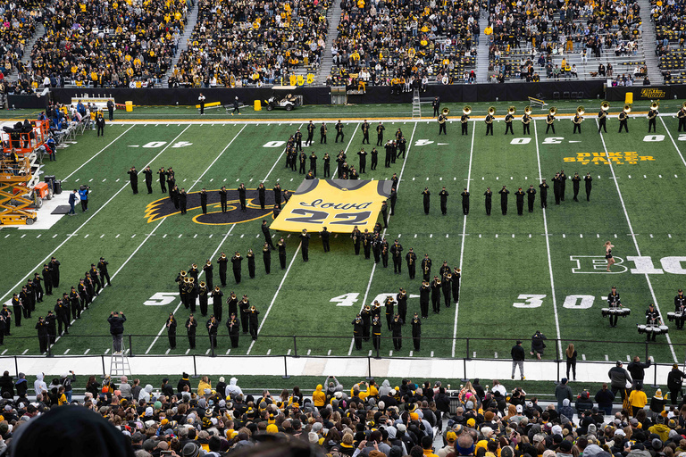 Hawkeye Marching Band perform a routine where Caitlin Clark shoots a basketball