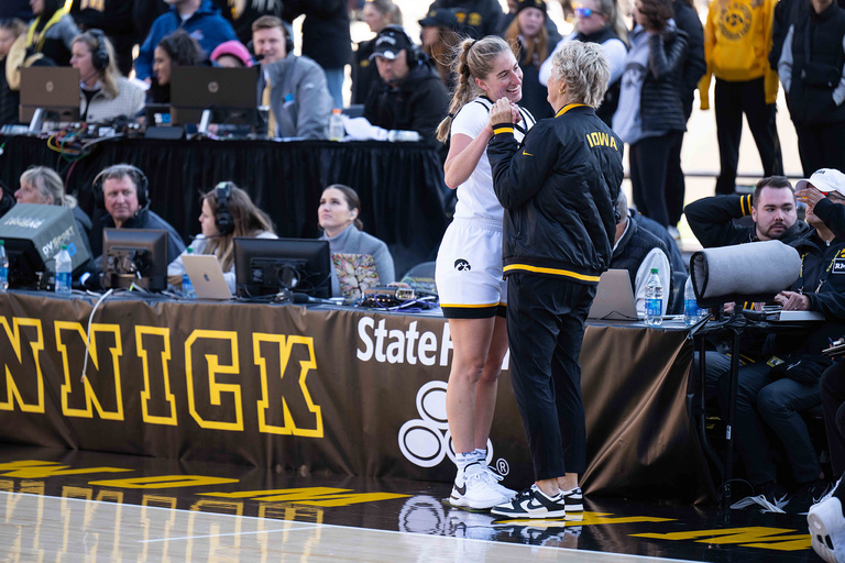 Kate Martin and Lisa Bluder share a moment on the sideline