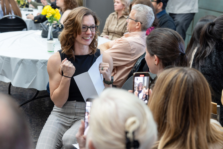A woman taking a video of her opening a letter
