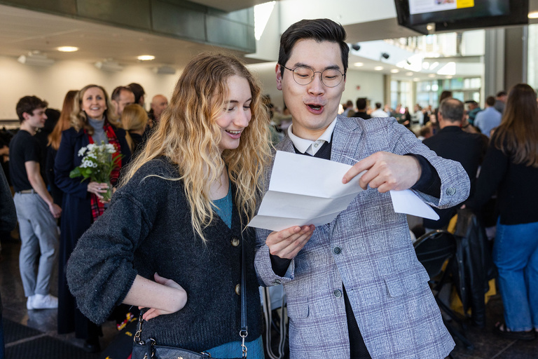 Two people reading a letter