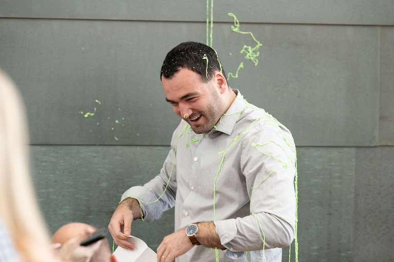 A man getting hit with silly string
