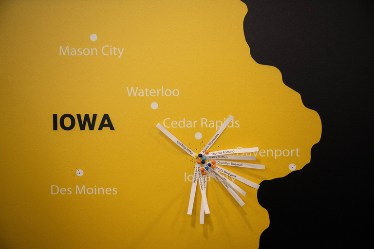 A map of Iowa with many pieces of paper on Iowa City