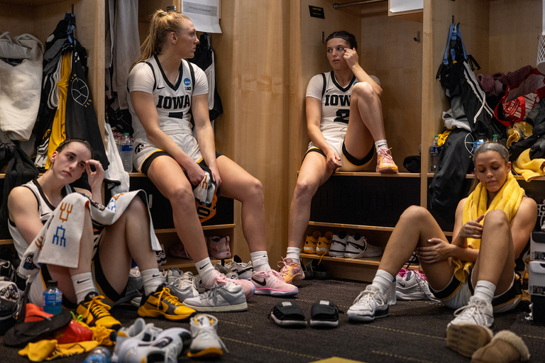 Iowa women's basketball players sitting in the locker room