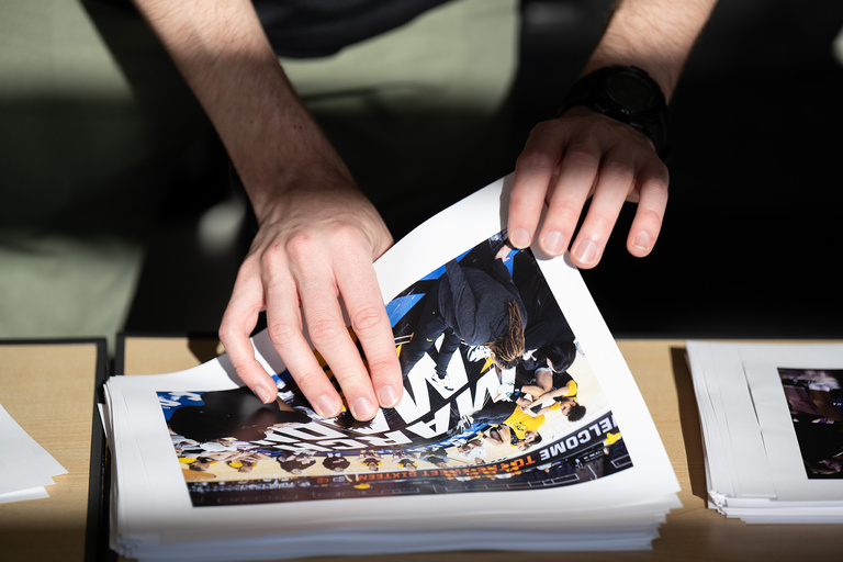 a photographer going through a stack of photos