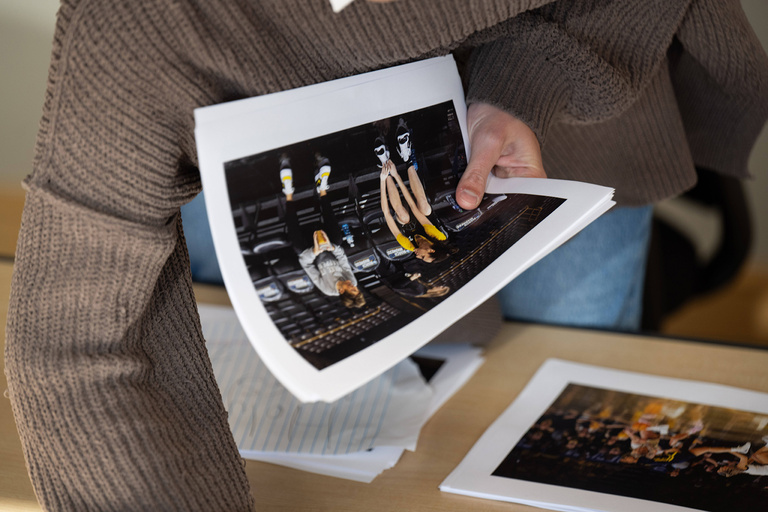 a photographer goes through a stack of photos
