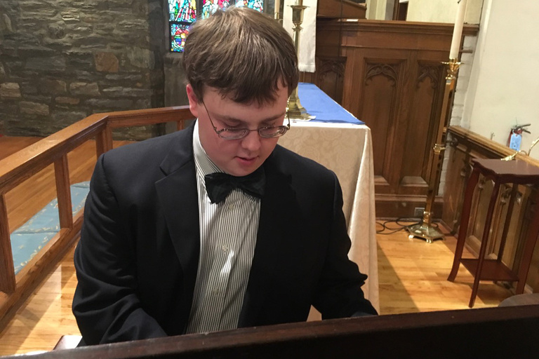 a boy playing piano