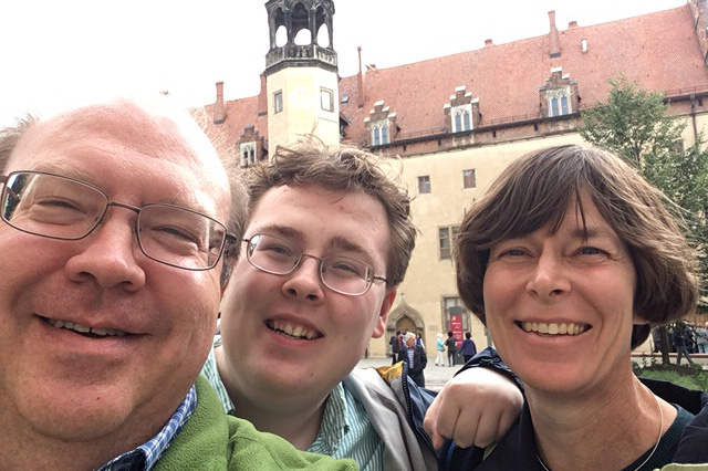 a family of three posing for a photo in Germany