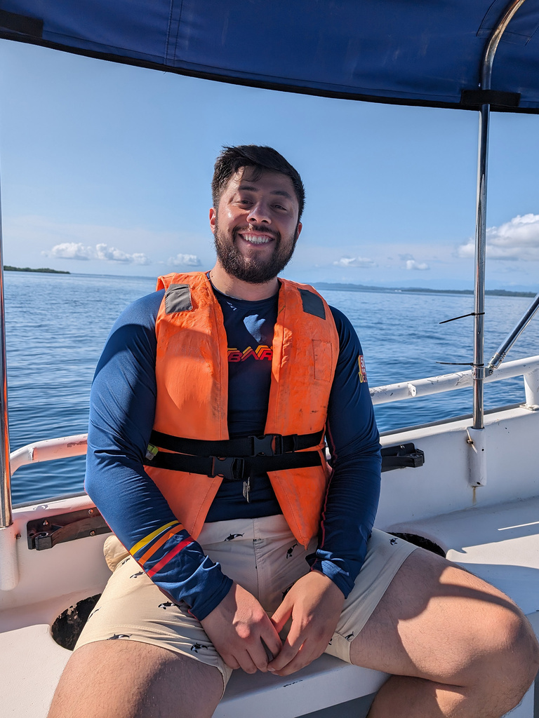 A man sitting on a boat smiling