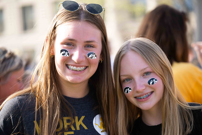 Two people with tiger hawks on their faces