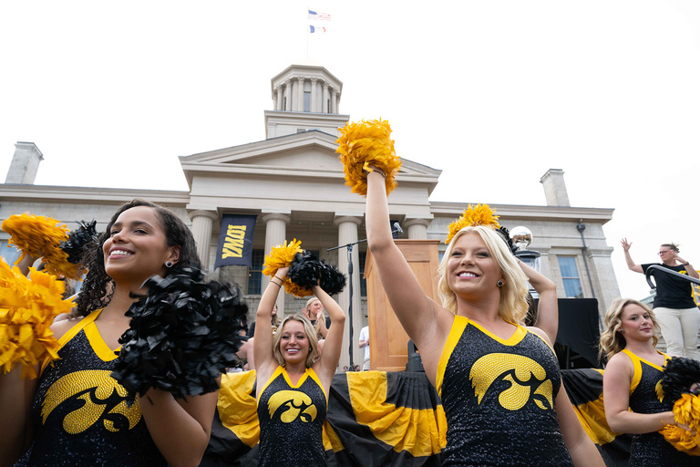 A group of cheerleaders in front of a crowd