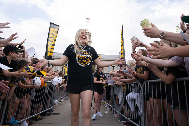 A woman walking down a row of fans