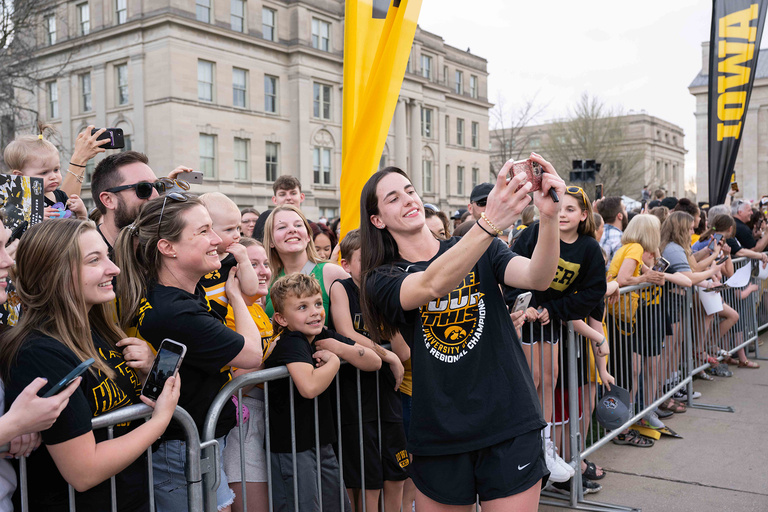 A woman taking a selfie with a group