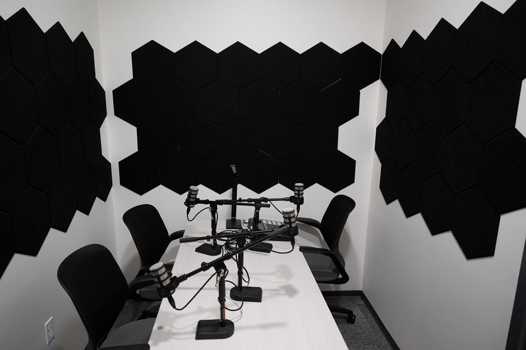 A room with desks and microphones