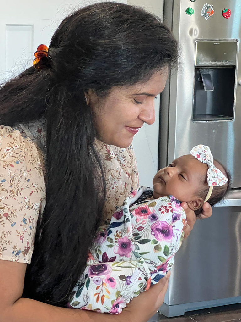 A woman holding a baby in her arms