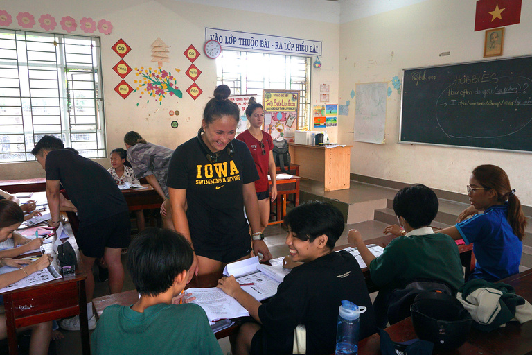 A teacher laughing with her students