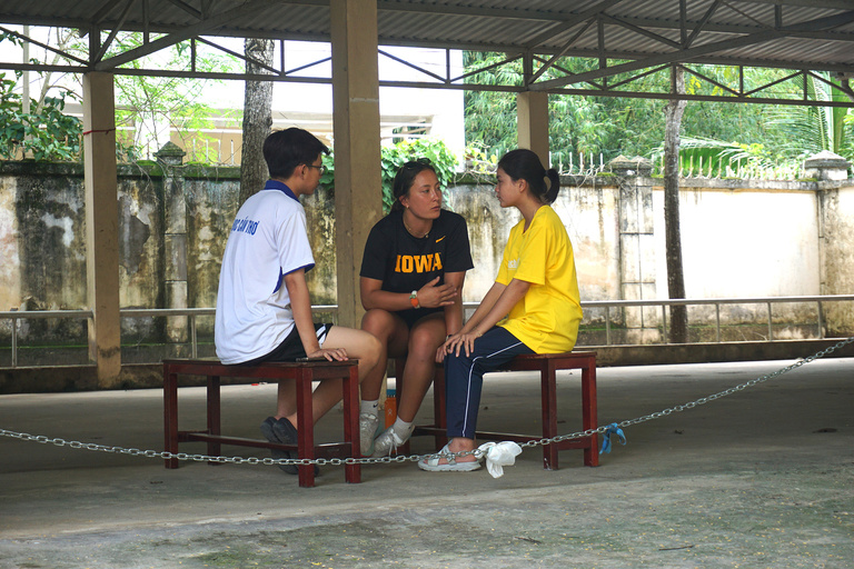 A teacher working with two of her students