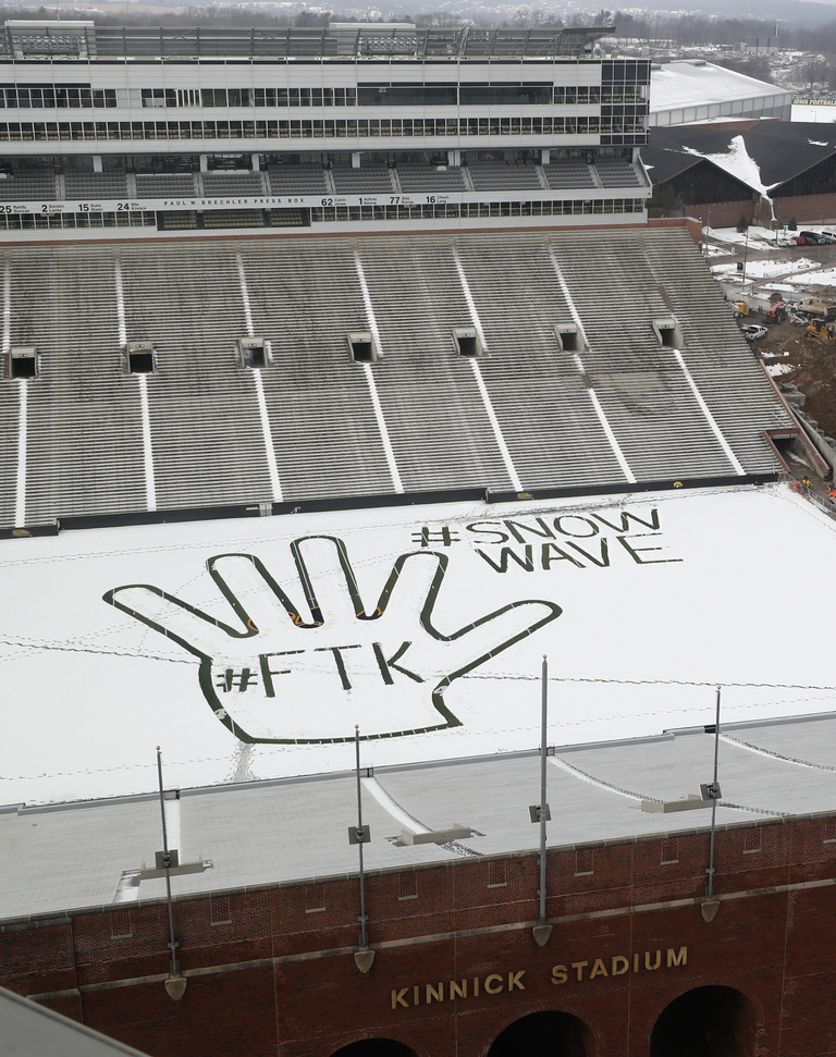 A hand made with tracks through snow