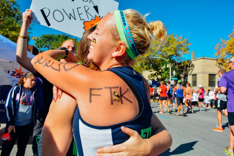 Two people hugging after running a race
