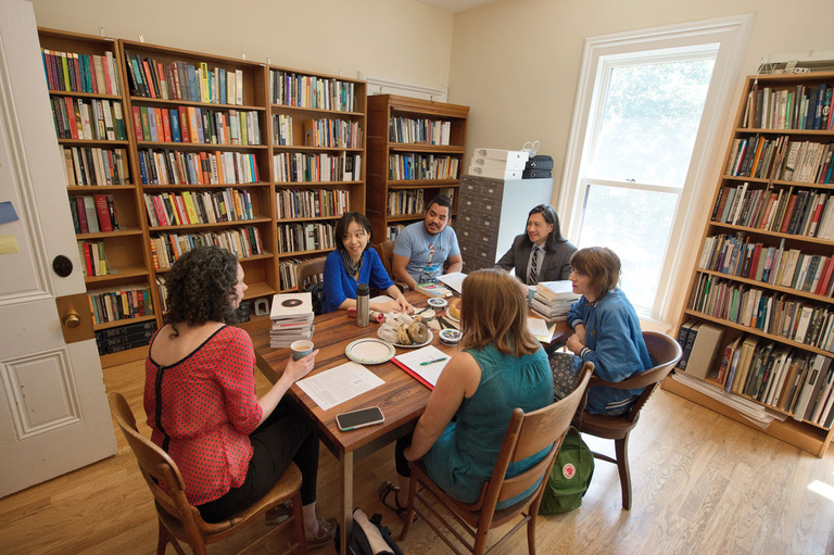 A group of people talking around a table