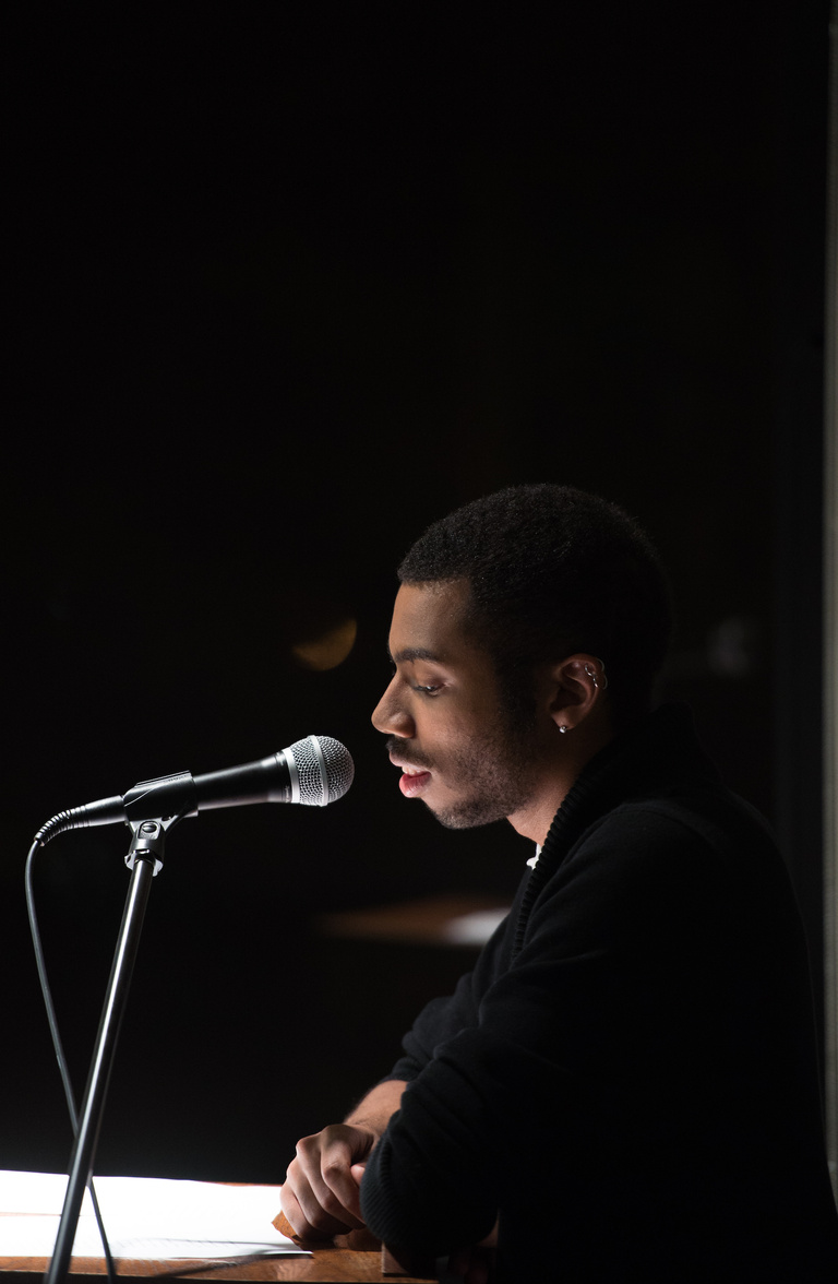 A man standing at a mic 