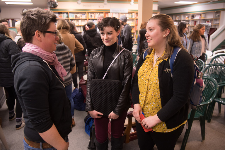 A group of people talking in a crowded room