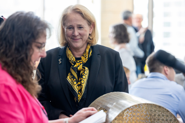 A woman congratulating another on their successes 
