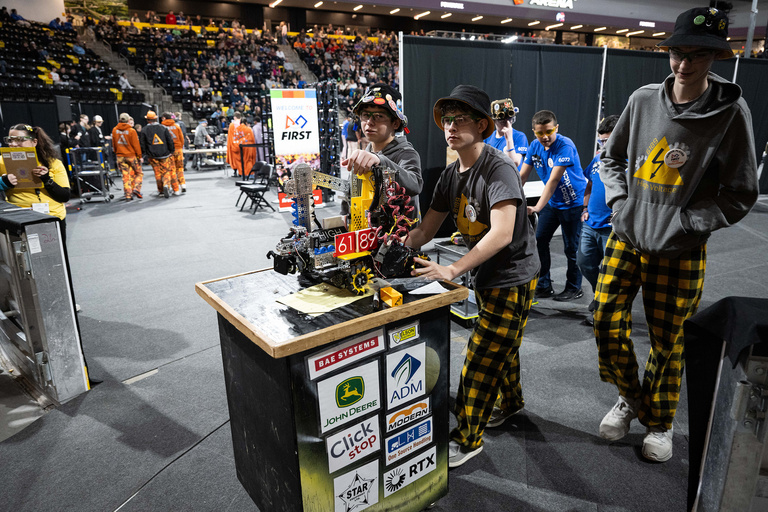 A team pushing their robot to the competition area