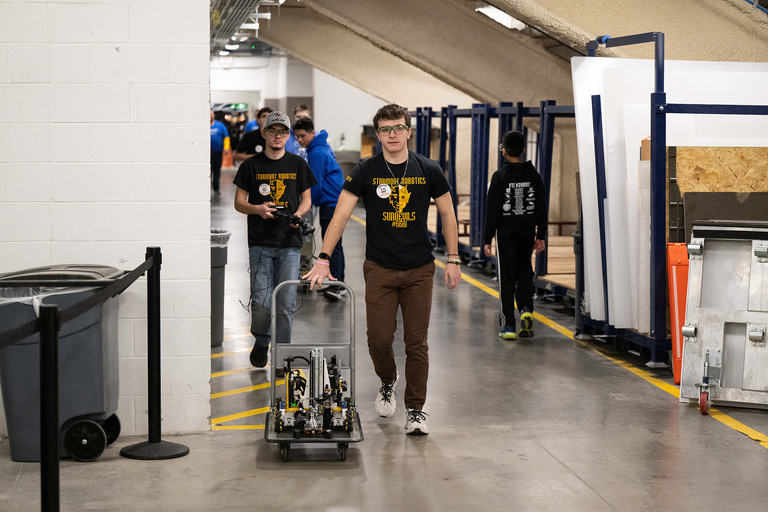 A person walking with their robot