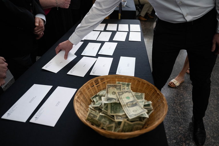 Letters on a table and a basket full of money