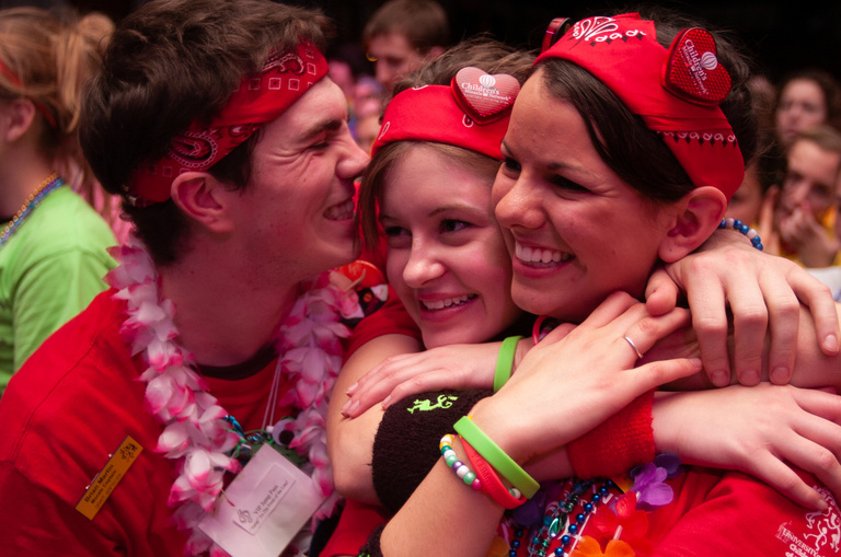 a group of people hugging and smiling