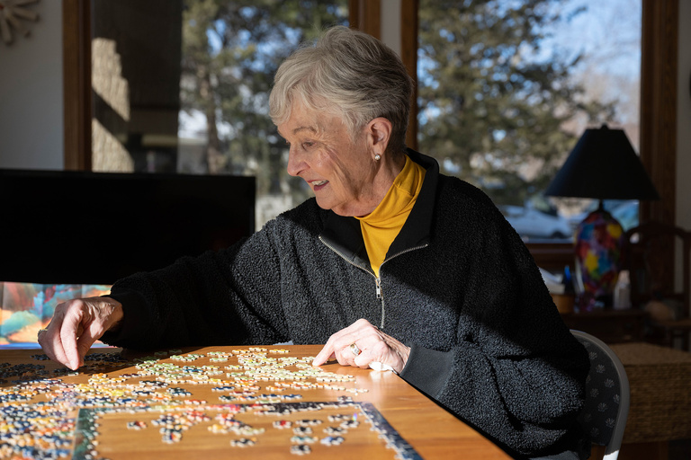 a woman working on a jigsaw puzzle