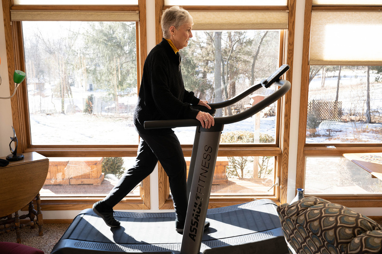a woman walking on a treadmill