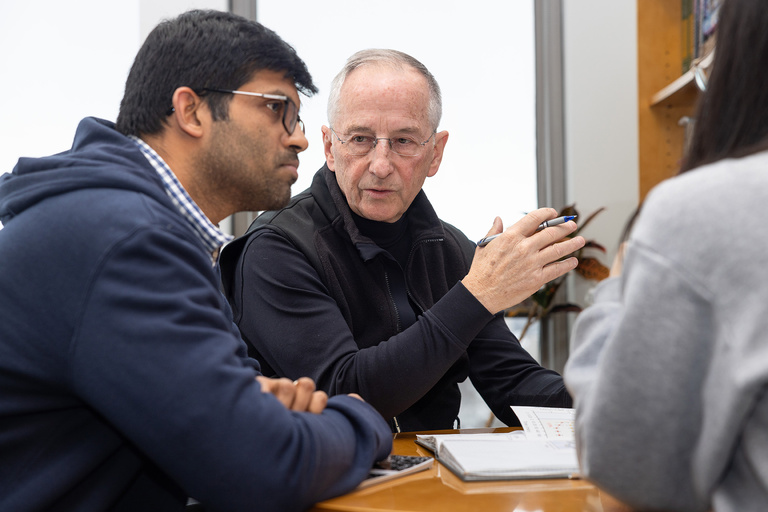 Michael Welsh in his lab speaking with a trainee