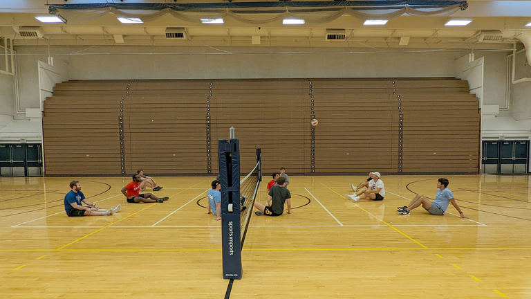students playing sitting volleyball