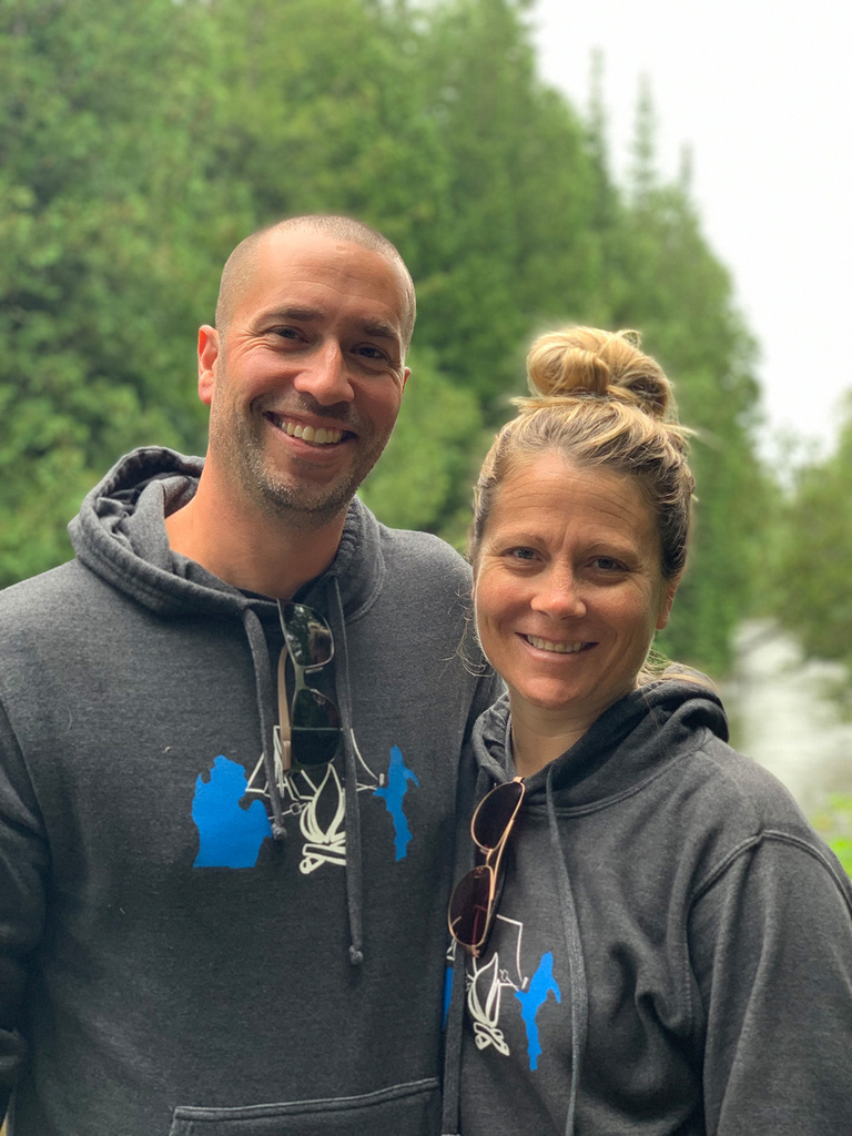 a man and woman posing for a shot during an outdoor activity