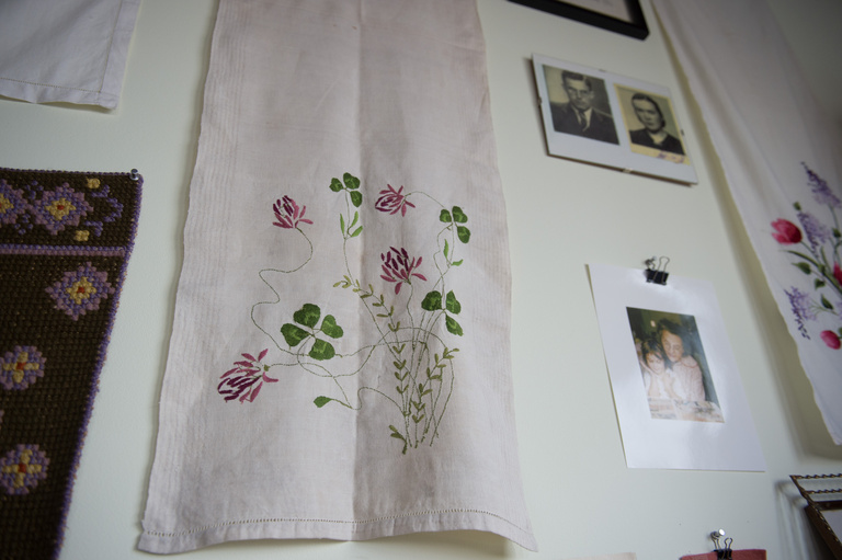 a cloth and different photos hung on a wall