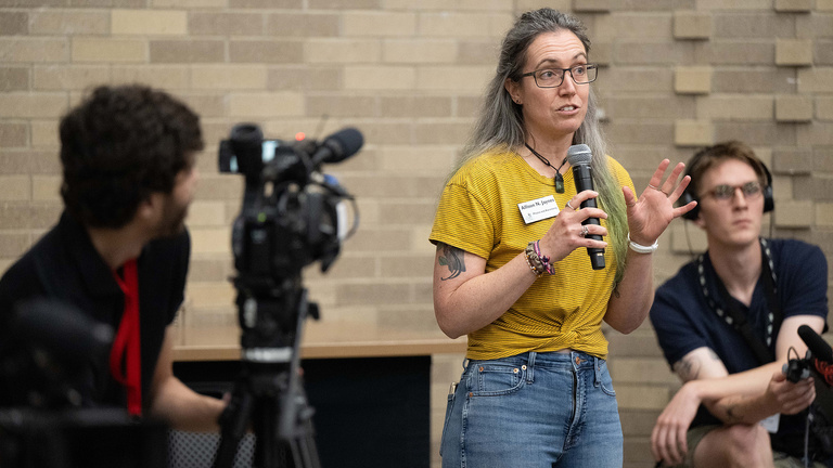 a woman speaks at an event