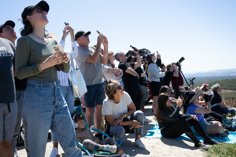 people watching a rocket launch